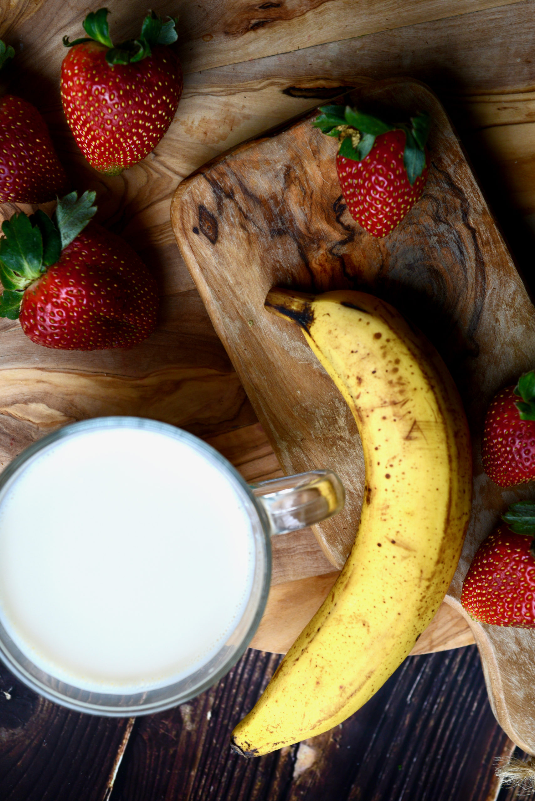3-ingredient strawberry banana smoothie areal shot of ingredients - banana, strawberries, and non-dairy milk