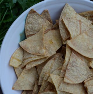 areal shot of white bowl filled with homemade oil-free oven-baked tortilla chips