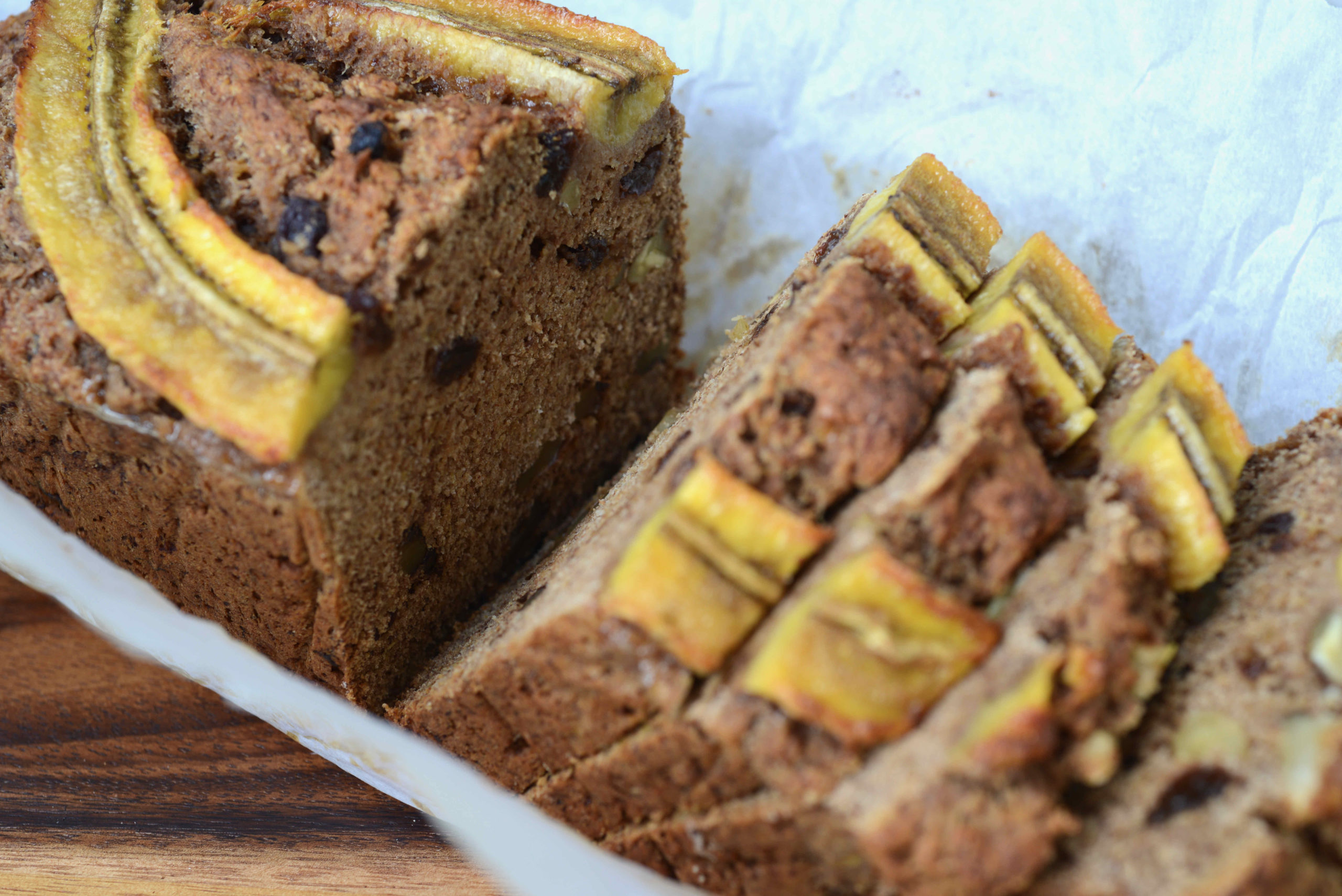 image of Fruit-Sweetened Healthy Vegan Banana Bread sliced - version with raisins and walnuts